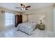 Bedroom with tiled floors, ceiling fan, and floral bedding at 4485 Herder St, Port Charlotte, FL 33948