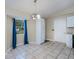Bright dining area features tile flooring, window, and white cabinets at 4485 Herder St, Port Charlotte, FL 33948