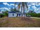 Newly renovated home with a blue door and palm tree at 4485 Herder St, Port Charlotte, FL 33948
