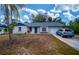 Newly renovated home with a blue door and attached garage at 4485 Herder St, Port Charlotte, FL 33948