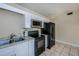 Updated kitchen with white cabinets, black appliances and granite countertops at 4485 Herder St, Port Charlotte, FL 33948