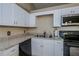 Modern kitchen with white cabinets, granite counters, and black appliances at 4485 Herder St, Port Charlotte, FL 33948
