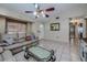 Spacious living room with tile floors, couches, and a ceiling fan at 4485 Herder St, Port Charlotte, FL 33948