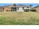 Large backyard with grassy area and home view at 1796 Scarlett Ave, North Port, FL 34289