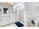 Bathroom with double vanity, large mirror, and walk-in shower at 1796 Scarlett Ave, North Port, FL 34289