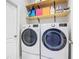 Laundry room with washer, dryer, and overhead shelving at 1796 Scarlett Ave, North Port, FL 34289