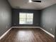 Bright bedroom featuring wood-look floors and a window at 18359 Gypsy Ave, Port Charlotte, FL 33954