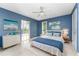 Bright main bedroom with blue accents and large windows at 27297 Voyageur Dr, Punta Gorda, FL 33983