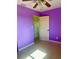 Bedroom with purple walls, a ceiling fan, and terrazzo floors at 30431 Holly Rd, Punta Gorda, FL 33982