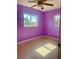 Bedroom with purple walls, a ceiling fan, and terrazzo floors at 30431 Holly Rd, Punta Gorda, FL 33982