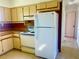 Cozy kitchen featuring wood-look countertops and cabinets and retro-style appliances at 30431 Holly Rd, Punta Gorda, FL 33982