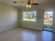 Living room with terrazzo floors and view of the front yard from a large window at 30431 Holly Rd, Punta Gorda, FL 33982