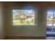 Bright living room with terrazzo floors and view of the front yard at 30431 Holly Rd, Punta Gorda, FL 33982