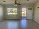 Living room with terrazzo floors and view of the front yard from a large window at 30431 Holly Rd, Punta Gorda, FL 33982