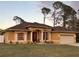 Attractive one-story house with brown roof, tan walls, and a two-car garage at 3100 Sheboygan Ave, North Port, FL 34286