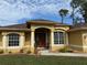 Front view of a lovely house with a double door entry and nicely landscaped yard at 3100 Sheboygan Ave, North Port, FL 34286