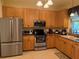 Well-equipped kitchen featuring stainless steel appliances and ample wood cabinetry at 3100 Sheboygan Ave, North Port, FL 34286