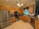 Spacious kitchen with stainless steel appliances and wood cabinets at 3100 Sheboygan Ave, North Port, FL 34286