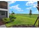 Private backyard with a view of a golf course and community at 43981 Boardwalk Loop # 2218, Punta Gorda, FL 33982