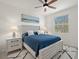 Bedroom with white platform bed, blue bedding, and ceiling fan at 43981 Boardwalk Loop # 2218, Punta Gorda, FL 33982