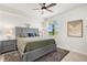 Bright bedroom with gray platform bed, ceiling fan, and large window at 43981 Boardwalk Loop # 2218, Punta Gorda, FL 33982