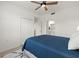 Blue and white bedroom with ceiling fan and access to bathroom at 43981 Boardwalk Loop # 2218, Punta Gorda, FL 33982