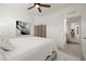 Simple bedroom with white platform bed and access to hallway at 43981 Boardwalk Loop # 2218, Punta Gorda, FL 33982