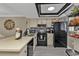 Modern kitchen with black appliances and breakfast bar at 25225 Rampart Blvd # 1901, Punta Gorda, FL 33983
