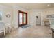 Bright and airy entryway with tile floors and elegant double doors at 4431 Gardner Dr, Port Charlotte, FL 33952