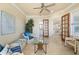 Relaxing sunroom with wicker furniture and view into kitchen at 4431 Gardner Dr, Port Charlotte, FL 33952