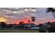 Sunset over the canal with houses and palm trees at 830 Pamela Dr, Punta Gorda, FL 33950