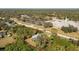 Aerial view of a single-story house with a pool and surrounding trees at 18565 Edgewater Dr, Port Charlotte, FL 33948