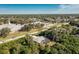 Single-story home with a screened-in patio and lush landscaping near a church at 18565 Edgewater Dr, Port Charlotte, FL 33948