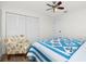 Bedroom with a full-size bed, ceiling fan, and patterned chair at 18565 Edgewater Dr, Port Charlotte, FL 33948