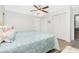 Bright bedroom with a queen bed, ceiling fan, and large closet at 18565 Edgewater Dr, Port Charlotte, FL 33948