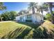 House exterior with palm trees and a lush green lawn at 18565 Edgewater Dr, Port Charlotte, FL 33948