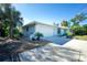 House exterior showcasing a two-car garage and landscaped yard at 18565 Edgewater Dr, Port Charlotte, FL 33948