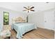 Spacious main bedroom with a king-size bed and light wood floors at 18565 Edgewater Dr, Port Charlotte, FL 33948