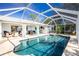 Relaxing enclosed pool with patio furniture and blue sky at 18565 Edgewater Dr, Port Charlotte, FL 33948