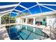 Enclosed pool with patio furniture and view of the house at 18565 Edgewater Dr, Port Charlotte, FL 33948