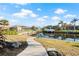 Concrete walkway leading to a canal with a boat and waterfront homes at 210 Divinci Dr, Punta Gorda, FL 33950