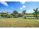 Spacious backyard with canal view, lush landscaping, and screened patio at 221 Sportsman Rd, Rotonda West, FL 33947