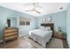 Cozy bedroom with a queen-size bed, dresser, and light blue walls at 221 Sportsman Rd, Rotonda West, FL 33947