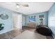 Light and airy bedroom with wood-look floors, a dresser, and a beanbag chair at 221 Sportsman Rd, Rotonda West, FL 33947