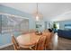 Bright dining room with a light wood table and six chairs, located near the living room at 221 Sportsman Rd, Rotonda West, FL 33947