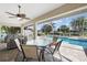 Relaxing pool area with patio furniture and a screened enclosure at 221 Sportsman Rd, Rotonda West, FL 33947