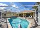 Refreshing pool with a screened enclosure and patio furniture at 221 Sportsman Rd, Rotonda West, FL 33947