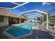 Relaxing screened pool area with a spacious patio at 221 Sportsman Rd, Rotonda West, FL 33947