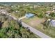 Aerial view of a canal-front home nestled in a lush, residential neighborhood at 28492 Royal Palm Dr, Punta Gorda, FL 33982