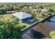 Aerial view showcasing a canal-front home with a screened porch and deck at 28492 Royal Palm Dr, Punta Gorda, FL 33982